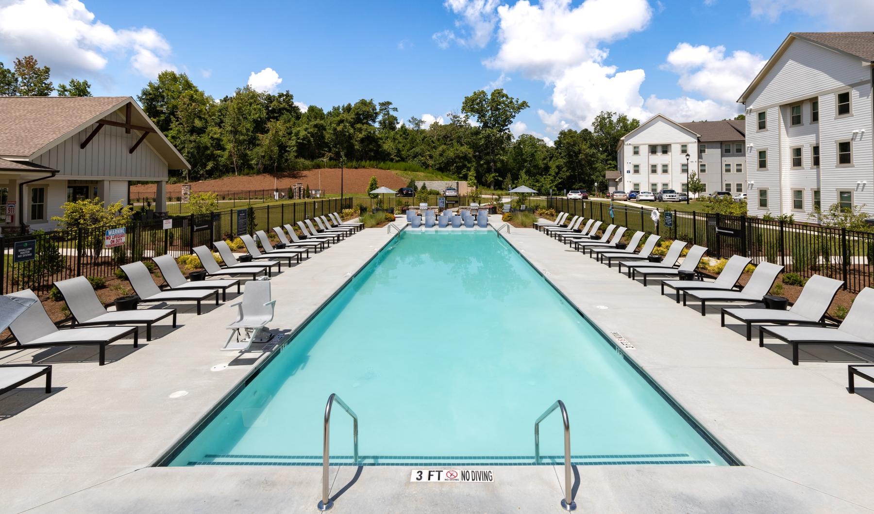 a swimming pool with chairs around it