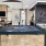 a room with a pool table and chairs