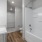 Bathroom with walk-in closet, sink,  toilet, and tub/shower combo,