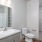Bathroom with walk-in closet, sink,  toilet, and tub/shower combo,