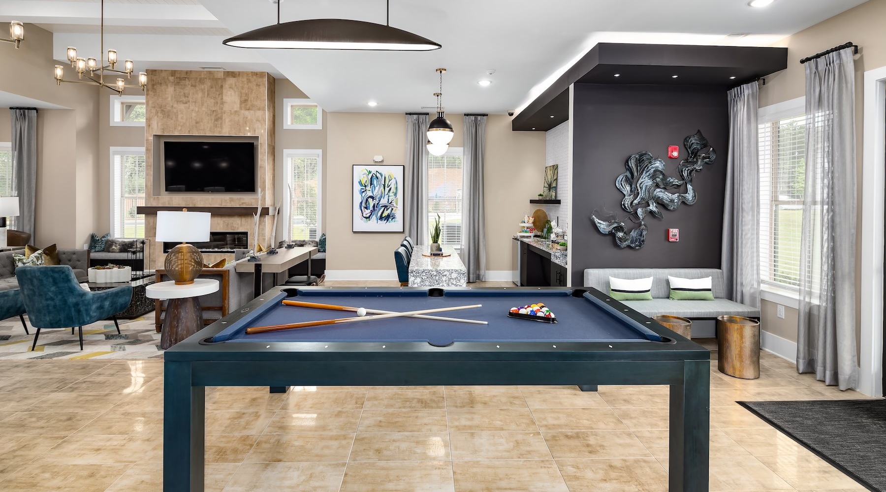 pool table in a lounge area with seating and a tv